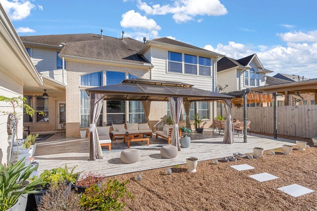 rear view of house featuring an outdoor living space and a patio