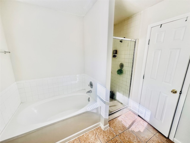 bathroom featuring tile patterned floors and shower with separate bathtub