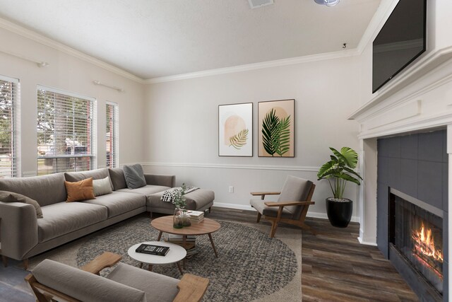 living room featuring a tile fireplace, dark hardwood / wood-style floors, and ornamental molding