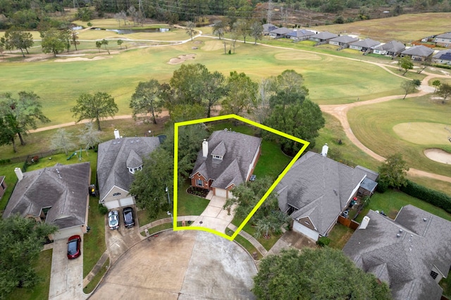 birds eye view of property with view of golf course and a residential view