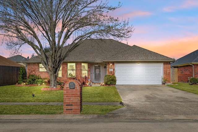 ranch-style house with a lawn and a garage