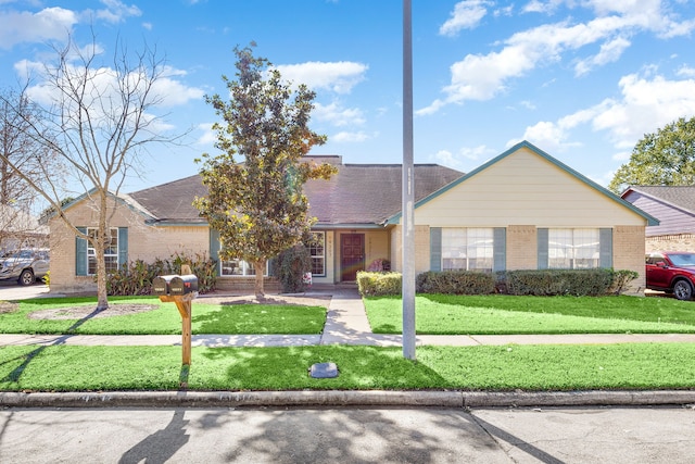 ranch-style home with a front yard