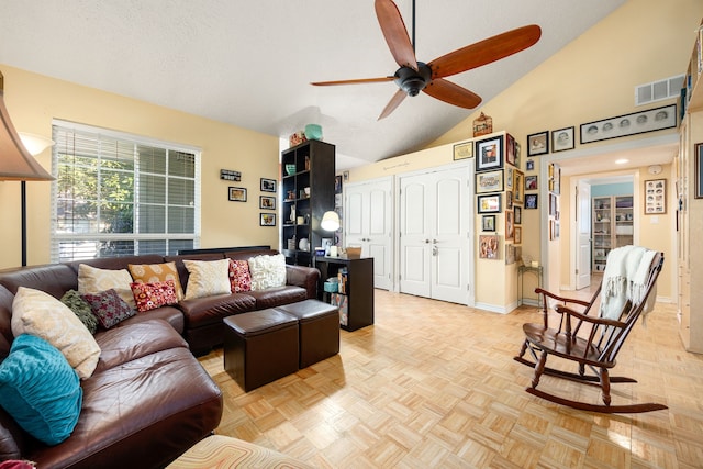 living room with ceiling fan, light parquet floors, and vaulted ceiling