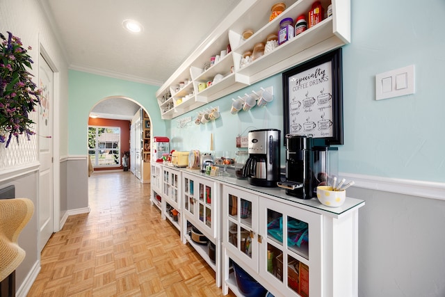 corridor with crown molding and light parquet floors