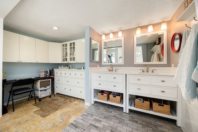 bathroom with vanity and a textured ceiling