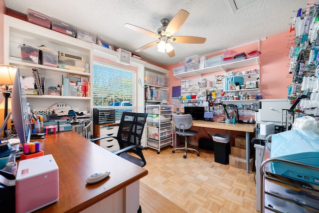 home office with a textured ceiling, light parquet flooring, and ceiling fan