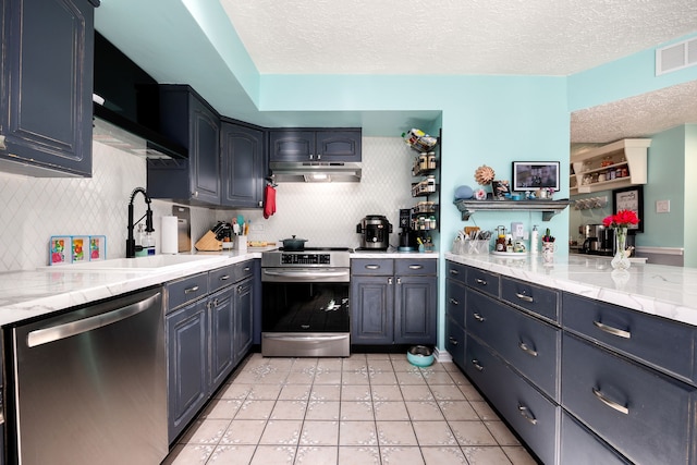 kitchen with sink, decorative backsplash, light tile patterned floors, a textured ceiling, and stainless steel appliances