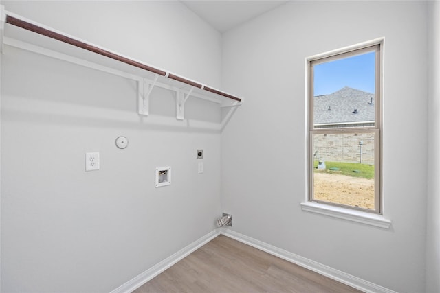 clothes washing area featuring hookup for a washing machine, hookup for a gas dryer, electric dryer hookup, and hardwood / wood-style floors