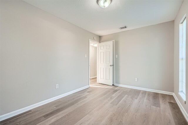 unfurnished room with light hardwood / wood-style flooring