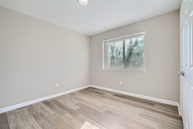 unfurnished room with light wood-type flooring