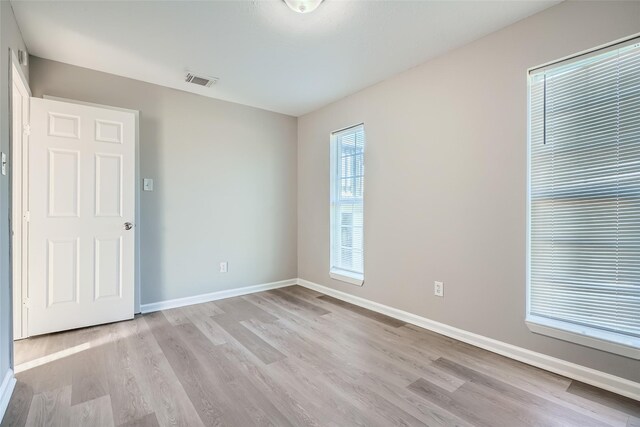 empty room with light hardwood / wood-style flooring