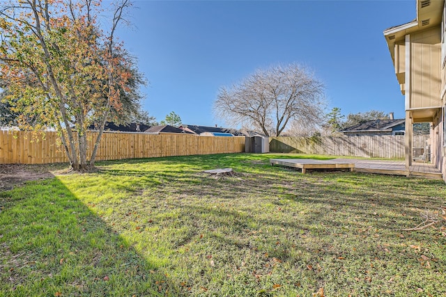 view of yard with a storage unit and a wooden deck