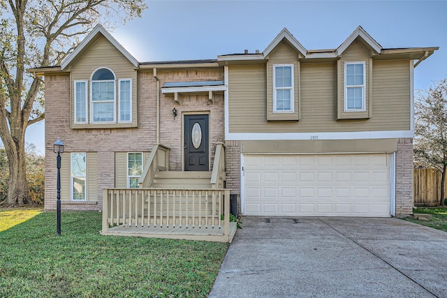 raised ranch with a garage and a front lawn