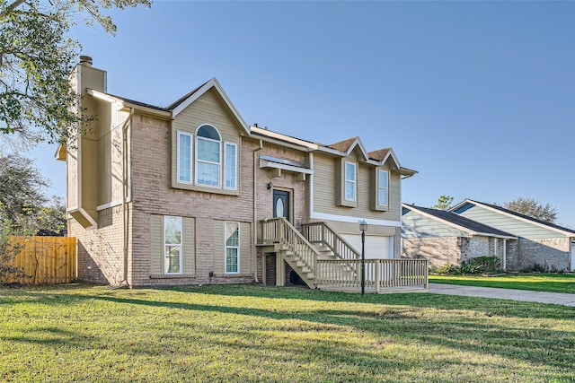 raised ranch featuring a front yard and a garage