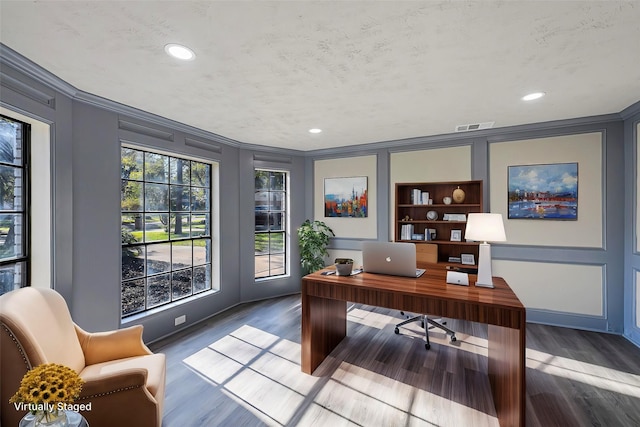 office area with hardwood / wood-style flooring and crown molding