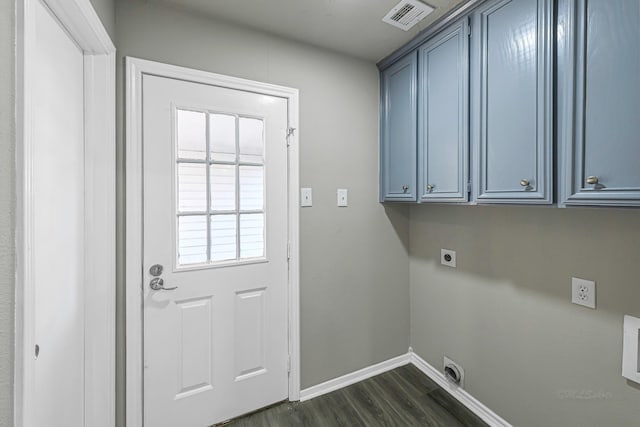 laundry room featuring electric dryer hookup, cabinets, and dark wood-type flooring