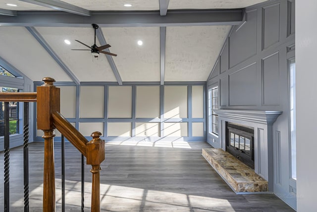 interior space with hardwood / wood-style floors, vaulted ceiling with beams, and ceiling fan