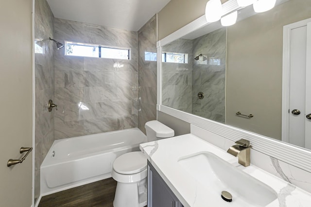 full bathroom with hardwood / wood-style floors, toilet, decorative backsplash, vanity, and tiled shower / bath