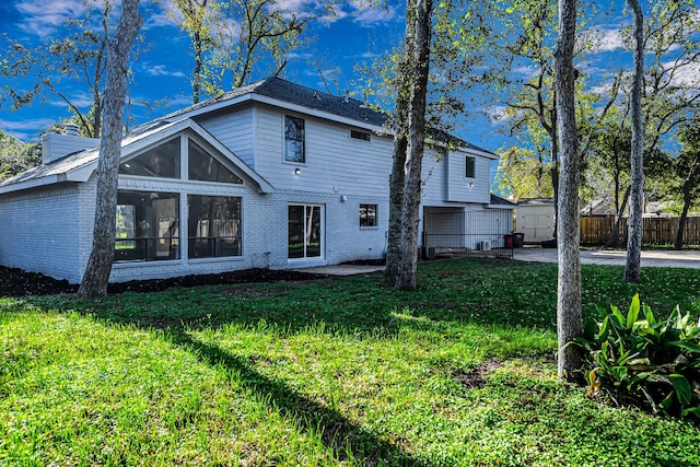 back of house featuring a yard and a patio