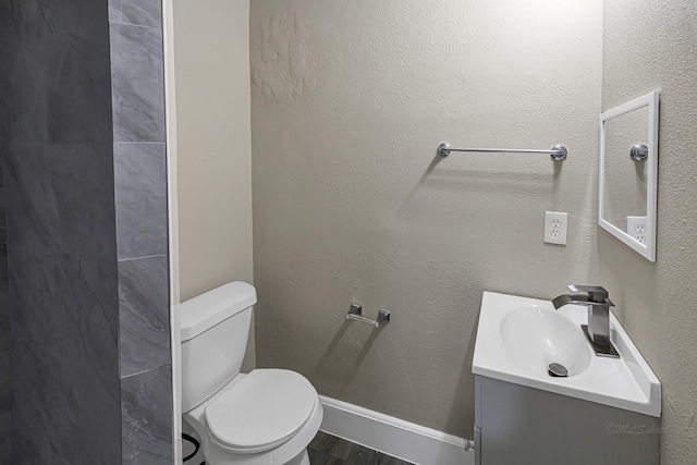 bathroom featuring hardwood / wood-style floors, vanity, and toilet