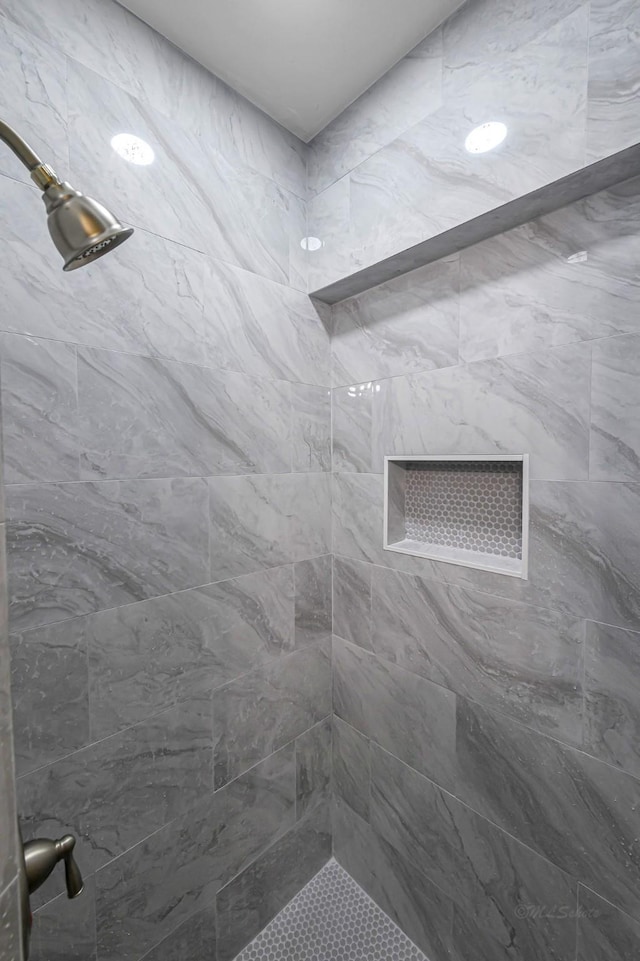 bathroom with tiled shower