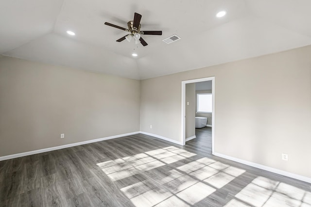 spare room with ceiling fan, lofted ceiling, and dark wood-type flooring