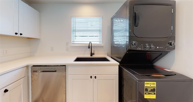 laundry area with stacked washer and clothes dryer and sink