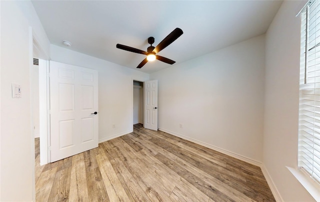 unfurnished bedroom with ceiling fan and light wood-type flooring