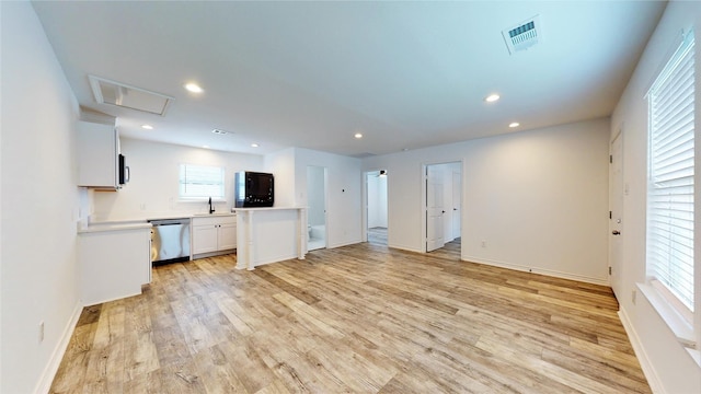 unfurnished living room featuring light hardwood / wood-style floors and sink