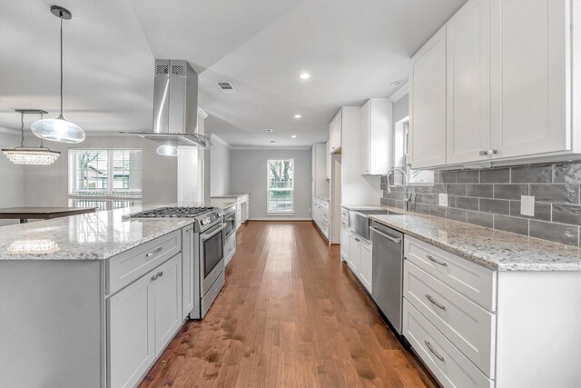 kitchen with stainless steel appliances, white cabinetry, island exhaust hood, and hanging light fixtures