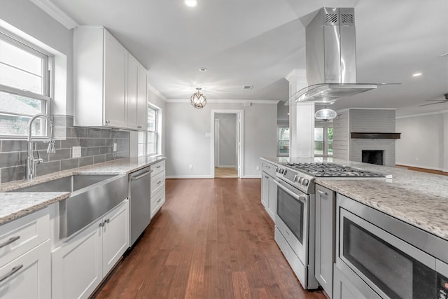 kitchen featuring stainless steel appliances, white cabinetry, island exhaust hood, and light stone countertops