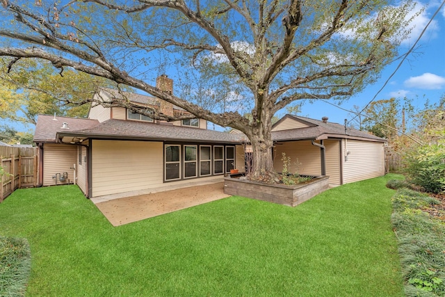 back of house with a lawn and a patio