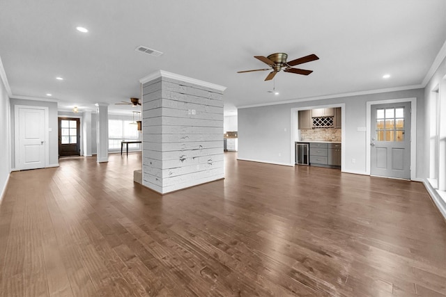 unfurnished living room with beverage cooler, ceiling fan, crown molding, and dark hardwood / wood-style floors