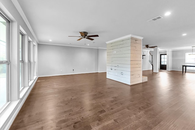 unfurnished living room featuring dark wood-type flooring, ceiling fan, and ornamental molding