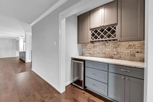 bar with gray cabinets, wine cooler, crown molding, decorative backsplash, and decorative columns