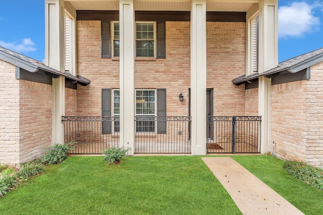 entrance to property with a lawn