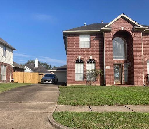 view of front facade with a front yard and a garage