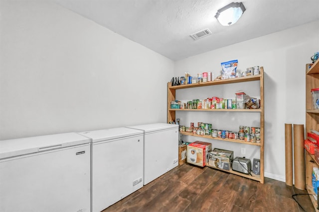 laundry room with dark hardwood / wood-style flooring and washing machine and dryer