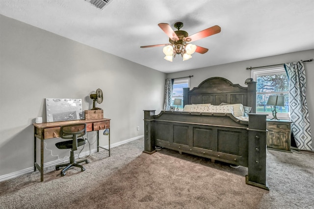 carpeted bedroom featuring multiple windows and ceiling fan