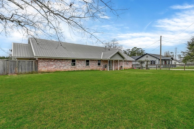 rear view of property with a lawn