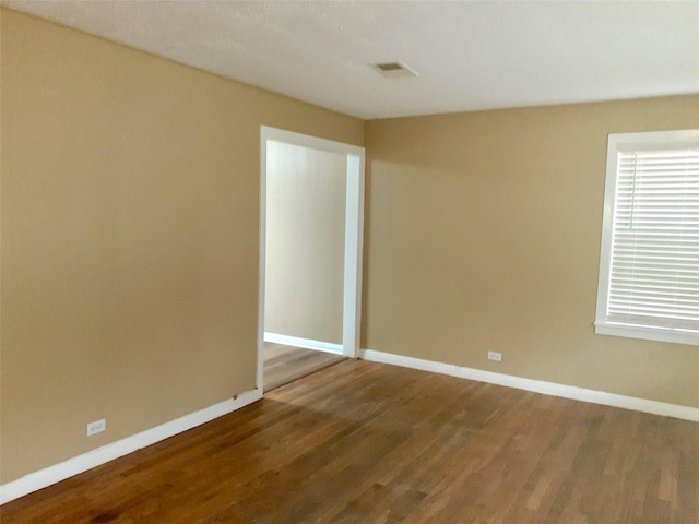 unfurnished room featuring hardwood / wood-style floors