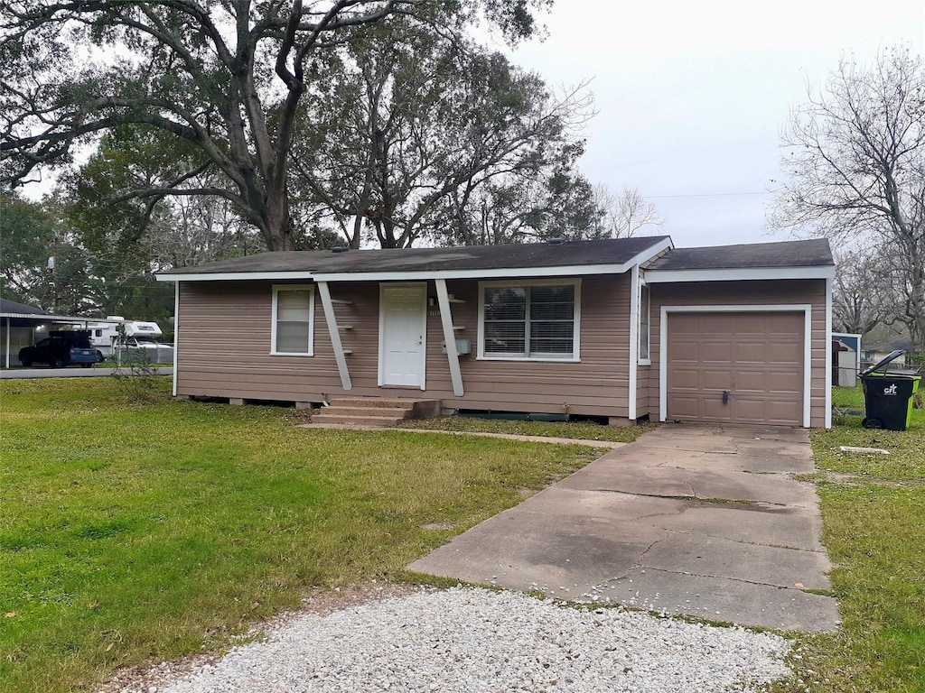 single story home featuring a front lawn and a garage