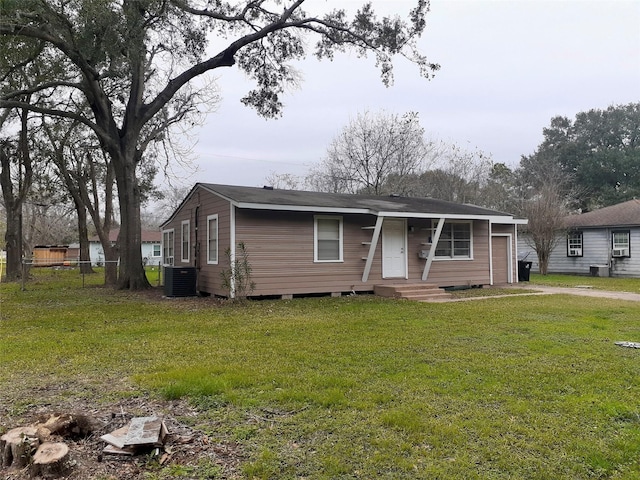 view of front of home with a front lawn and cooling unit