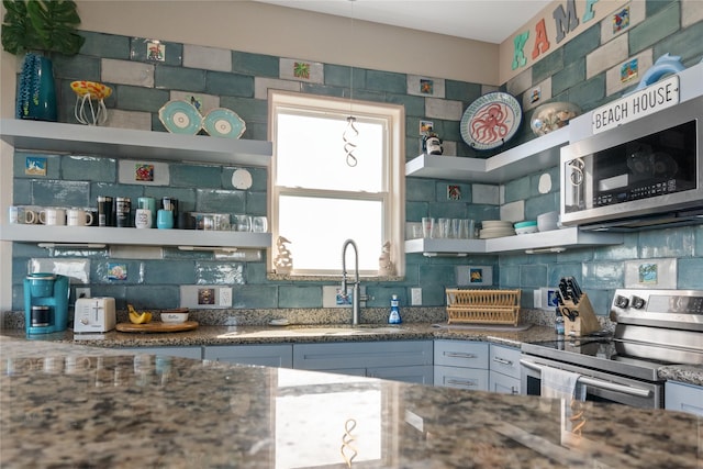 kitchen with tasteful backsplash, sink, and stainless steel appliances