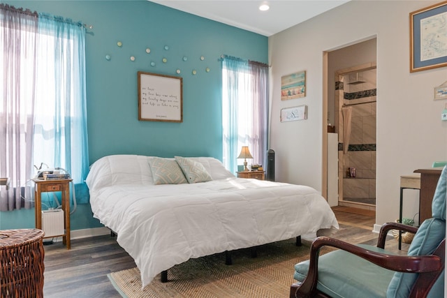 bedroom with multiple windows, radiator heating unit, and dark wood-type flooring