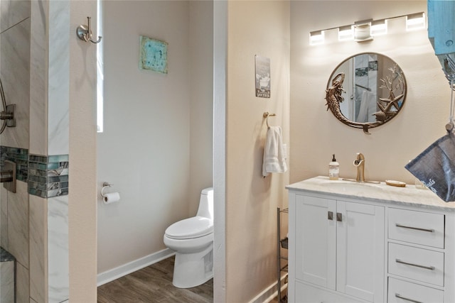 bathroom with hardwood / wood-style floors, vanity, and toilet