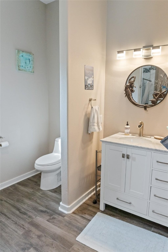 bathroom featuring hardwood / wood-style floors, vanity, and toilet