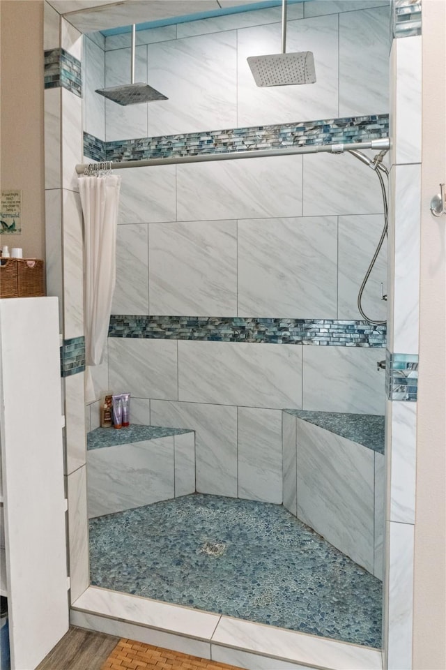 bathroom with a tile shower