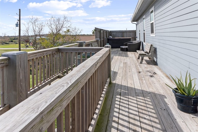 wooden deck featuring a hot tub