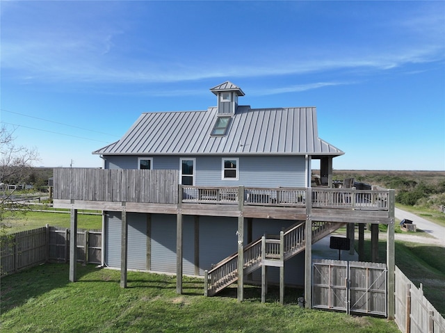 rear view of property with a lawn and a deck